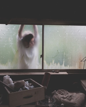 woman leaning on window