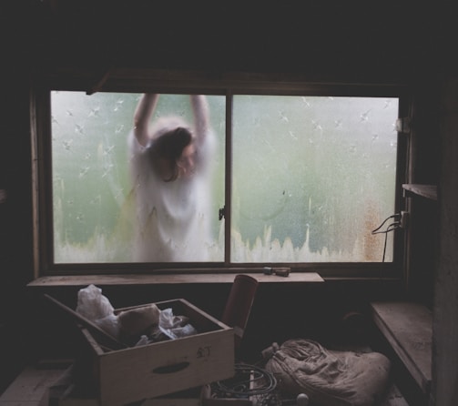 woman leaning on window