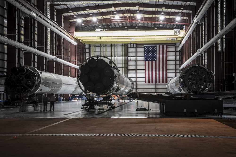 three huge gray metal towers inside building