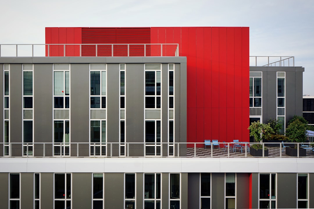 aerial photography of red and gray building, Grey and red modern building