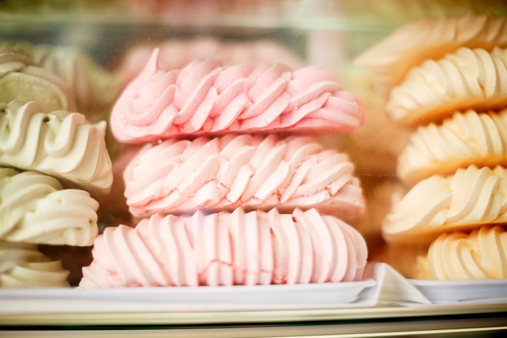 Stacks of swirly colorful meringue desserts at a bakery