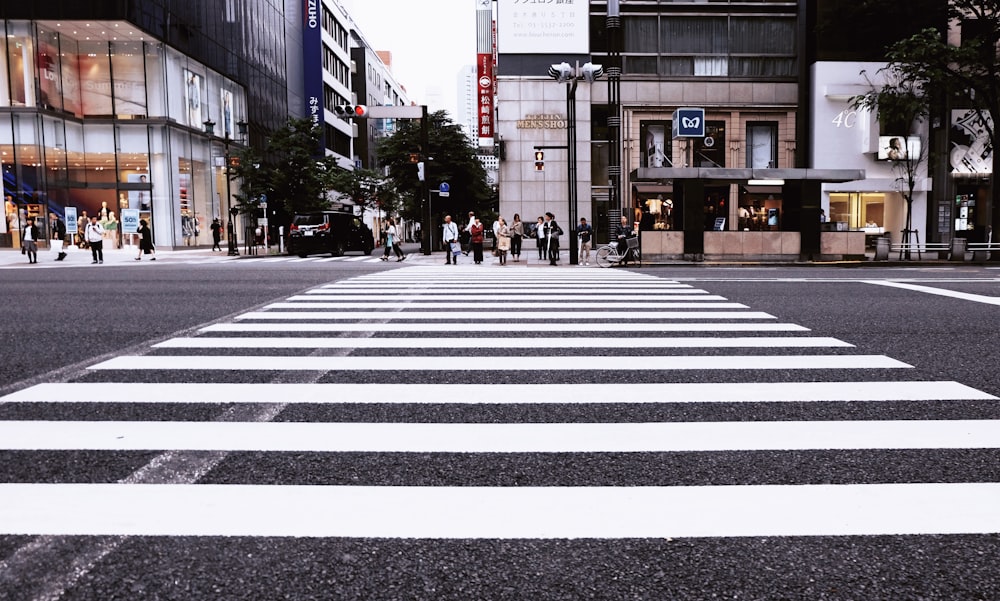 people standing on pedestrian lane