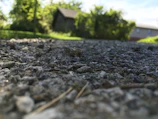 Wide shot of a gravel driveway winding through a residential property.