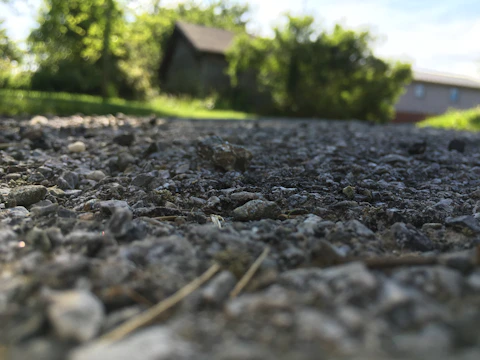 Wide shot of a gravel driveway winding through a residential property.