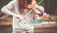 person playing brown violin