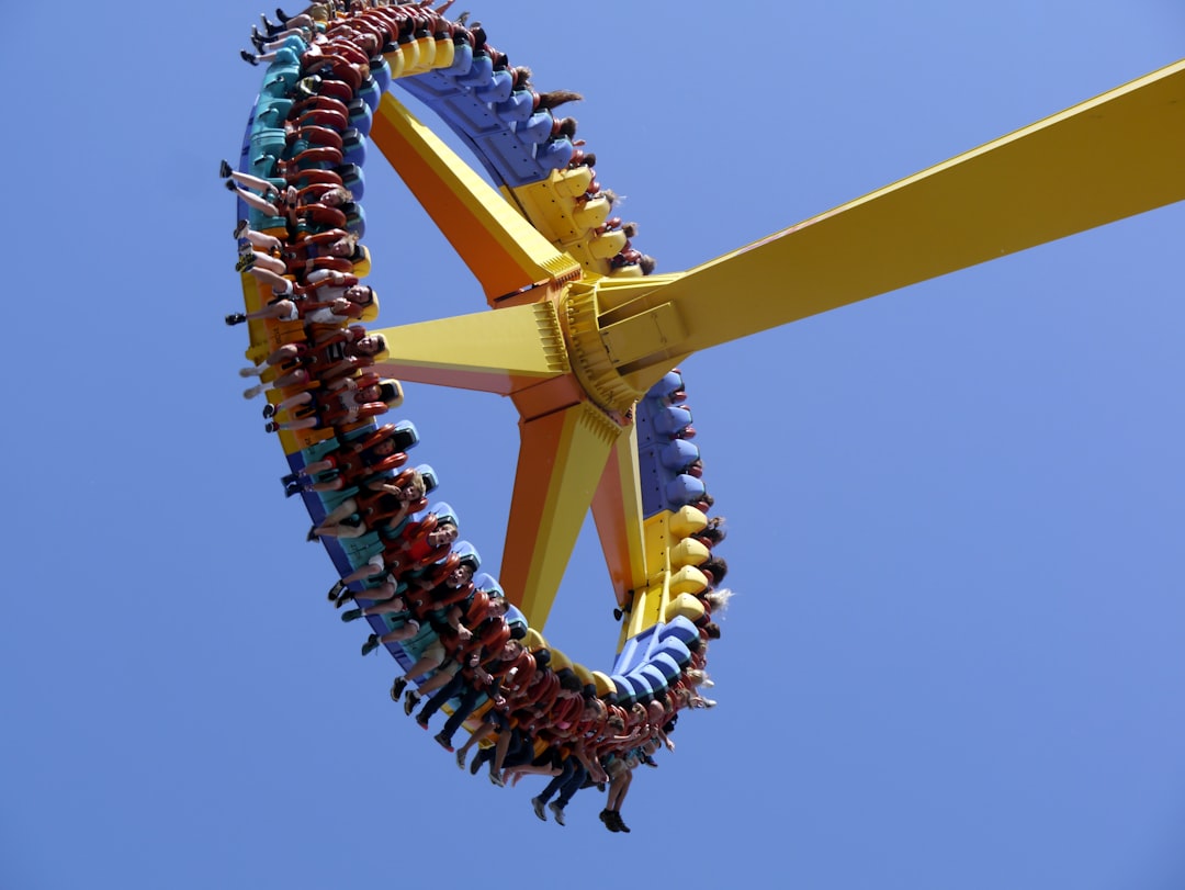 low-angle photography of people on yellow playground equipment