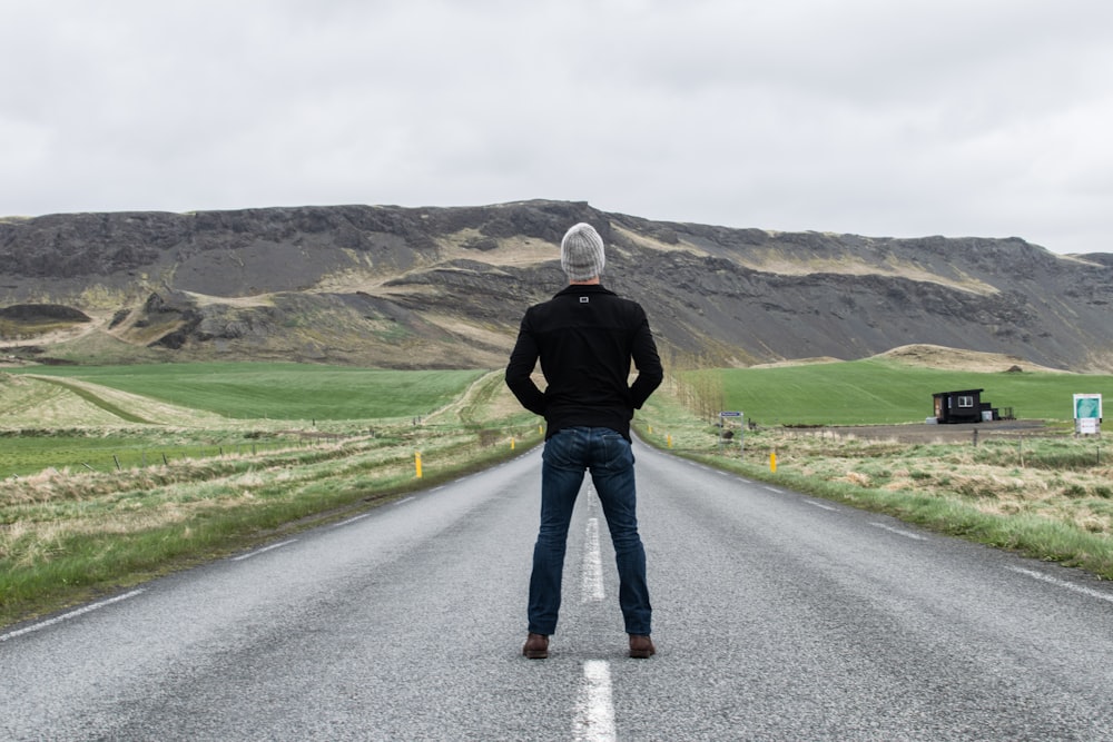 man standing on road