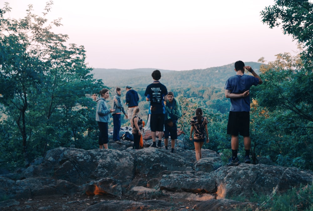 a group of people standing on top of a mountain