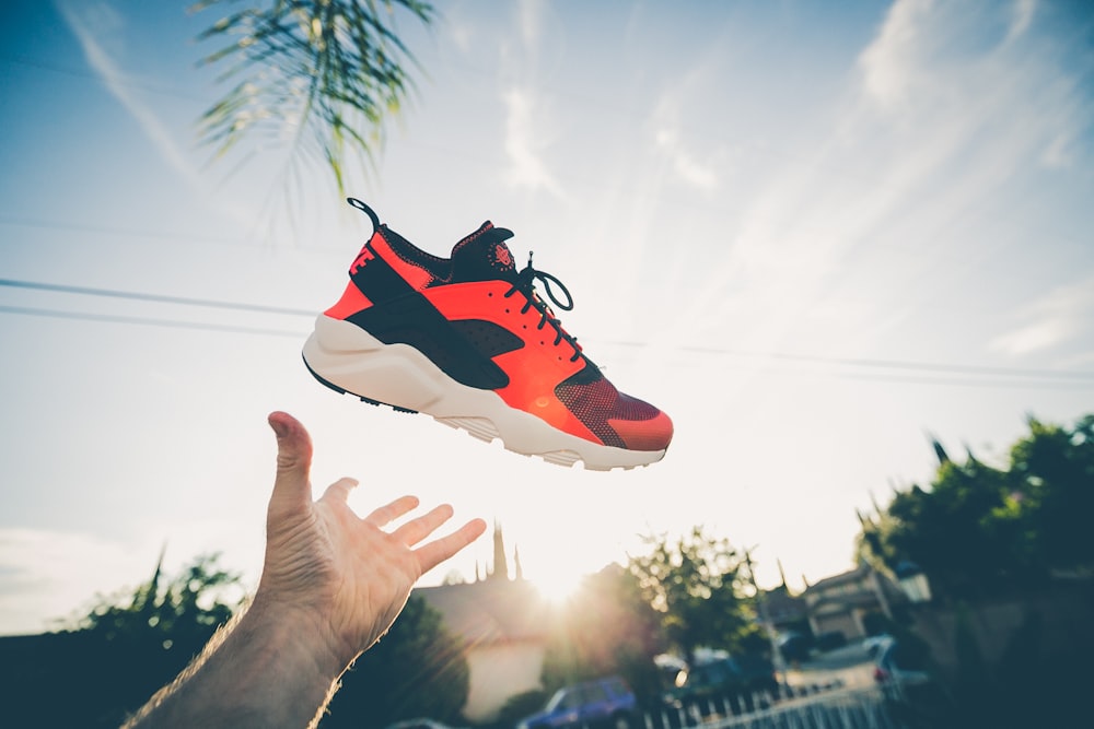 unpaired orange and white Nike Air Huarache