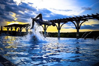 An action shot of a swimmer performing a flip turn at the edge of the pool.