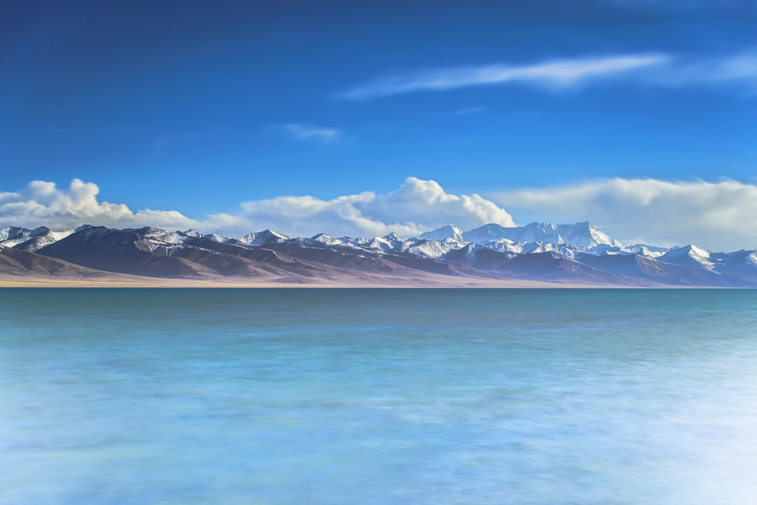 mountain near on body of water photography,
