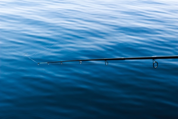 A scenic view of a popular beginner fishing spot with gentle ripples on the water.