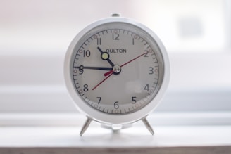 A sleek digital alarm clock with a modern design.