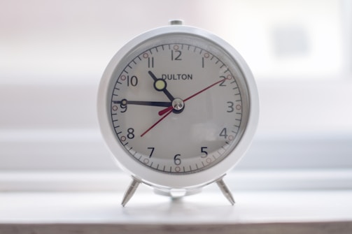 A sleek digital alarm clock with a modern design.
