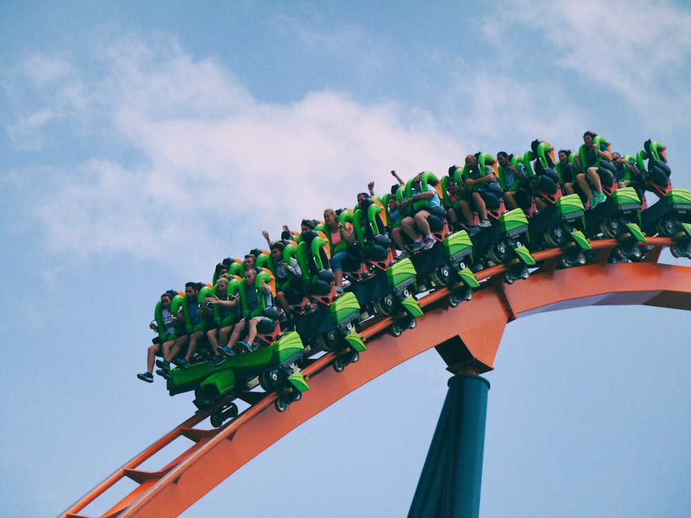 people riding on roller coaster