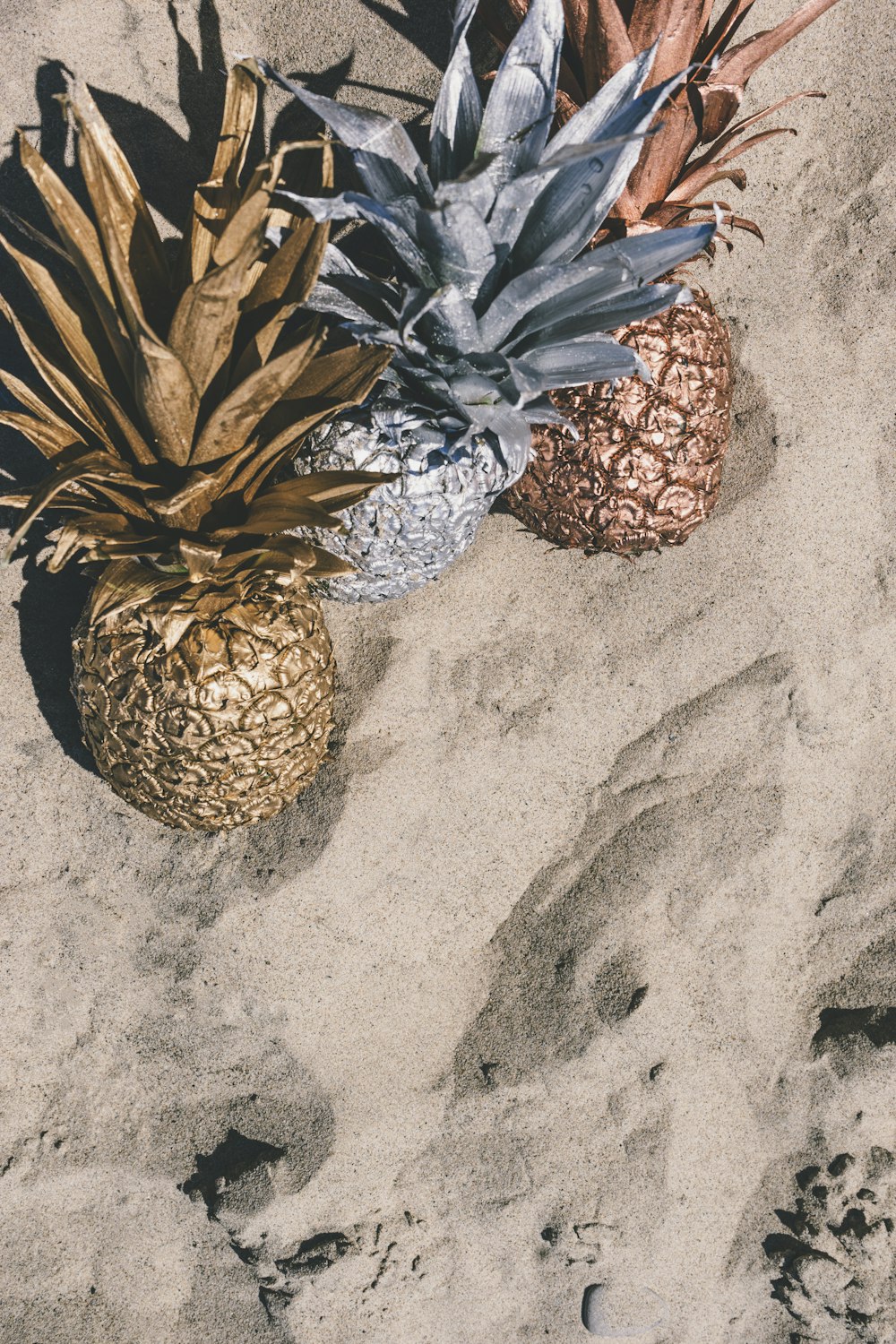 decorative pineapples on gray sand