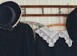 A selection of vintage clothing items hanging on a rustic rack.