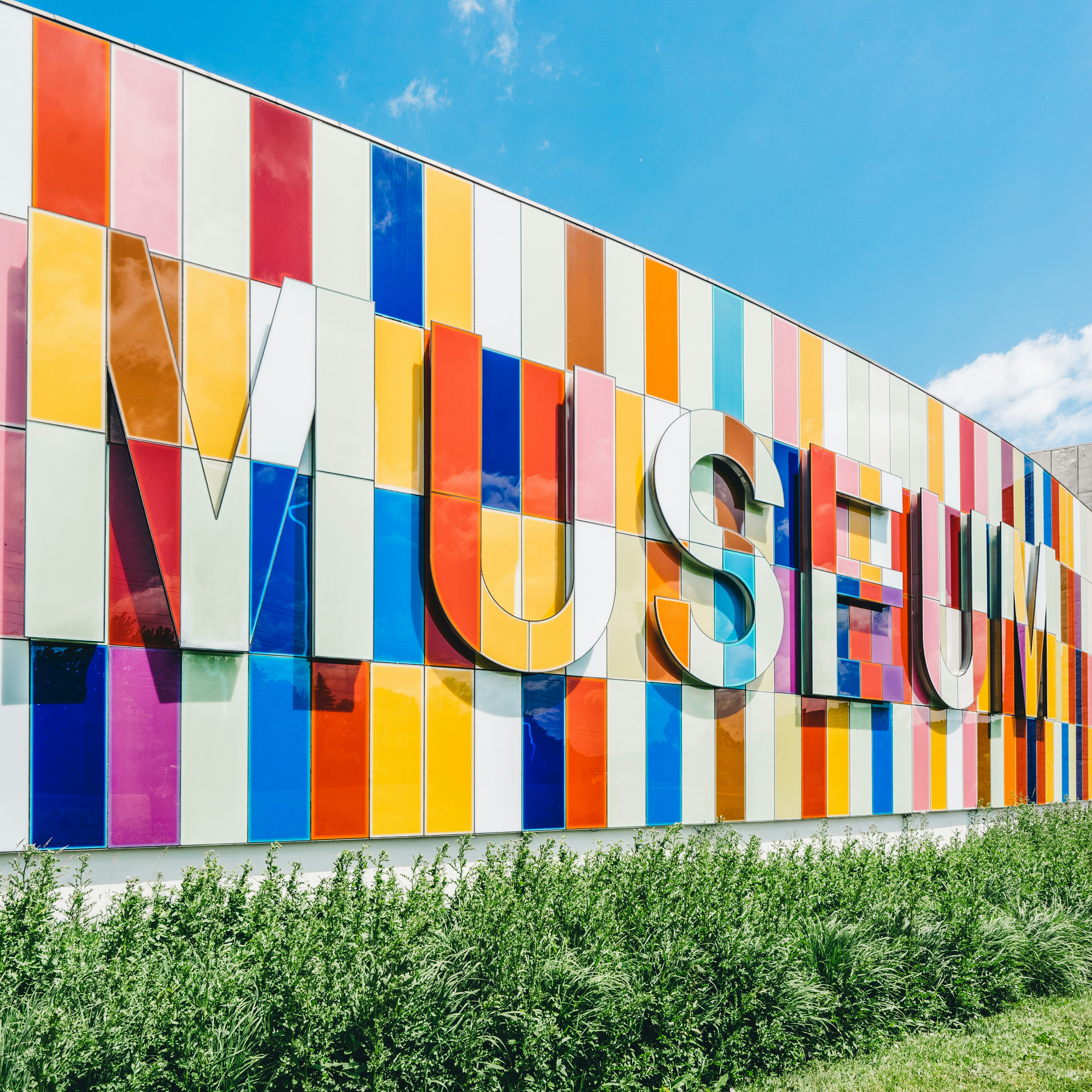 photo of Museum signage near green leafed plants