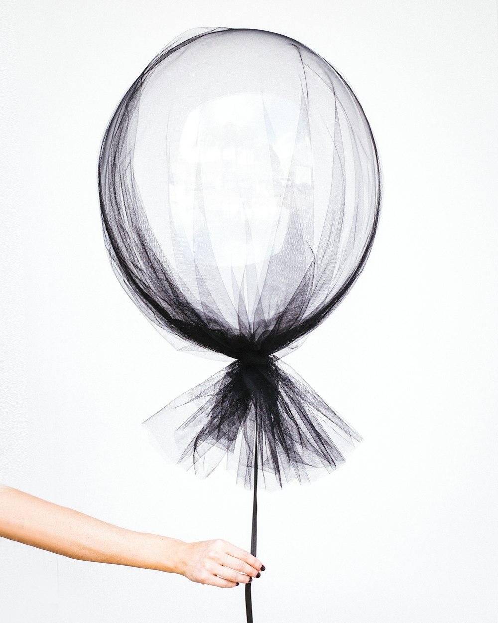 person holding black balloon decal