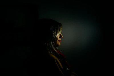 Sensual woman in soft lighting, evoking mystery and allure.