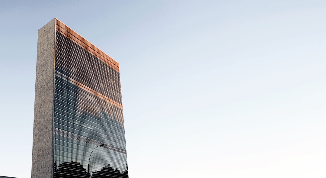 low angle photo of curtain wall building at daytime, Sunset over UN building