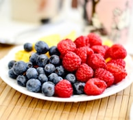 strawberries and blue berries on palte