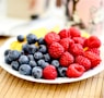 strawberries and blue berries on palte