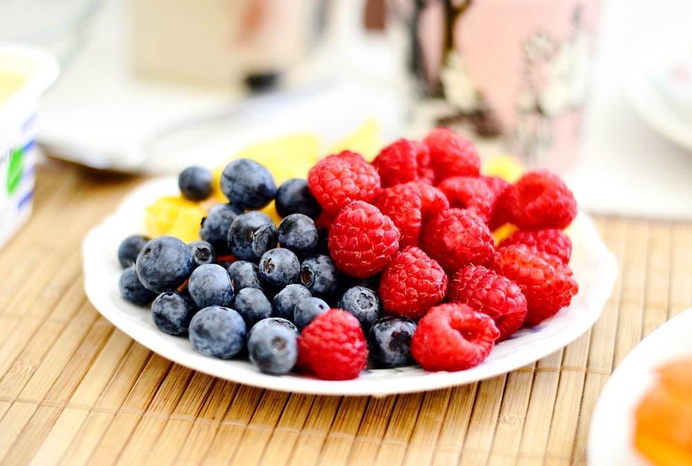 strawberries and blue berries on palte