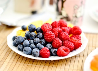 strawberries and blue berries on palte