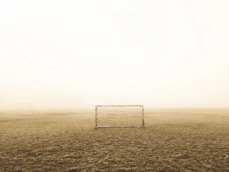 soccer goal on brown field