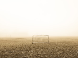 soccer goal on brown field