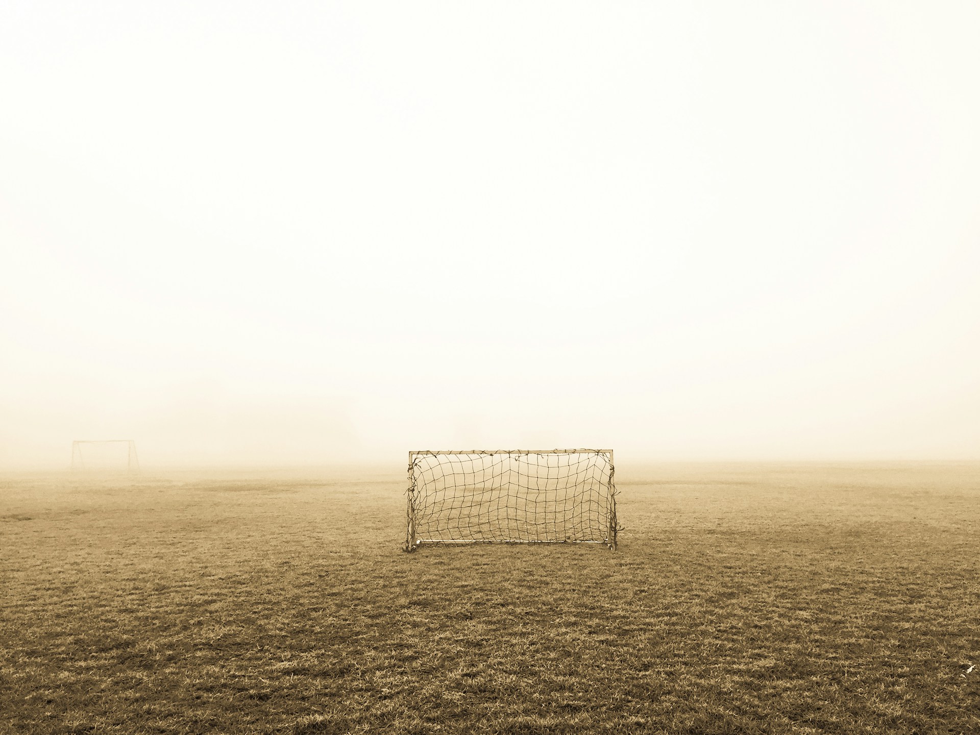 soccer goal on brown field