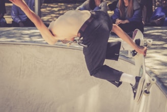 Close-up of a skateboarder carving a perfect line on a curved bowl edge.