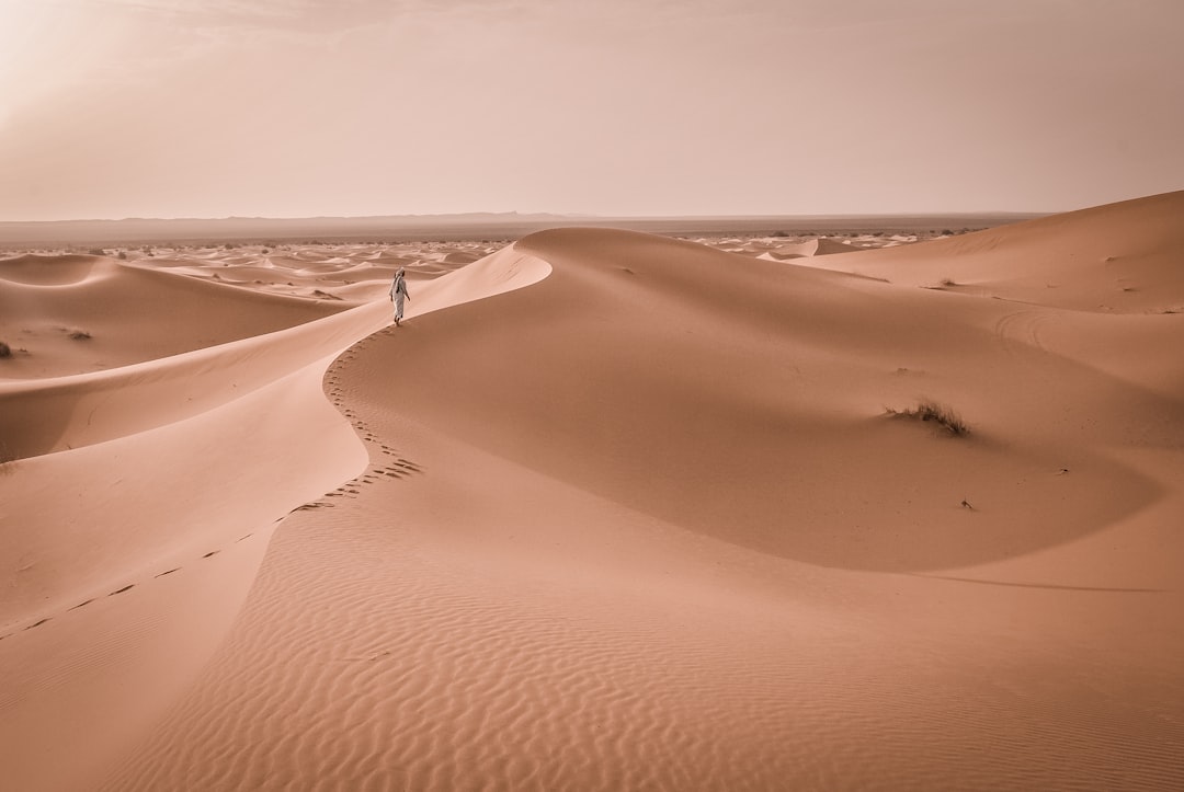 person walking on desert