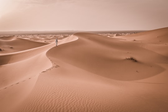 person walking on desert in Merzouga Morocco