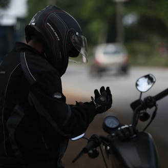 selective focus photo of man wearing motorcycle suit