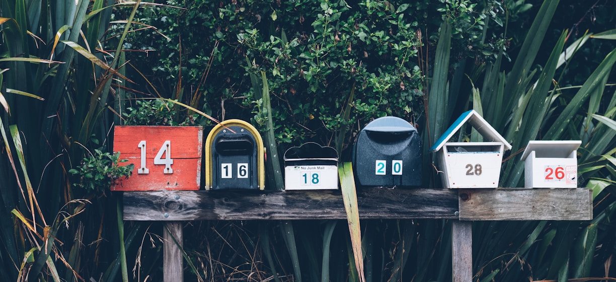 six assorted-color mail boxes