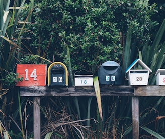 six assorted-color mail boxes