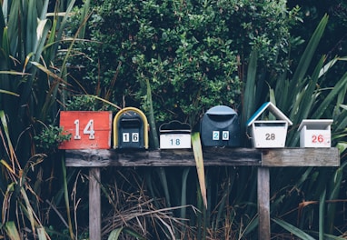 six assorted-color mail boxes