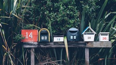 six assorted-color mail boxes