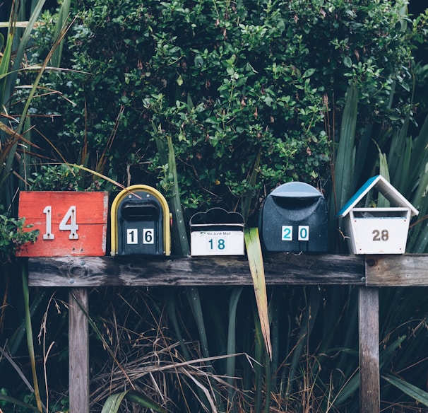 six assorted-color mail boxes