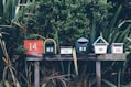 six assorted-color mail boxes