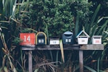 six assorted-color mail boxes