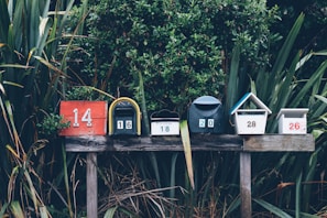 six assorted-color mail boxes