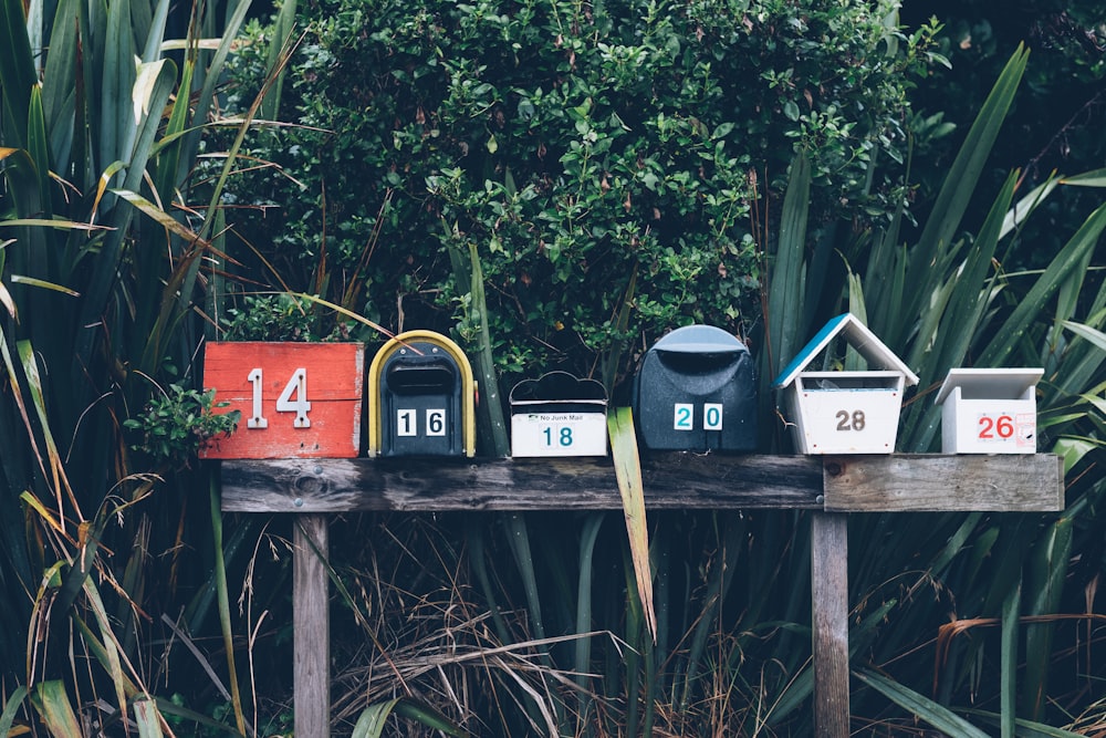 six assorted-color mail boxes