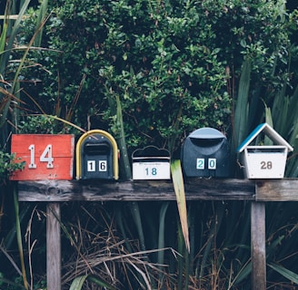 six assorted-color mail boxes