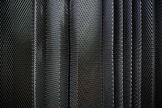 A metal criss-cross grid in undulating layers
