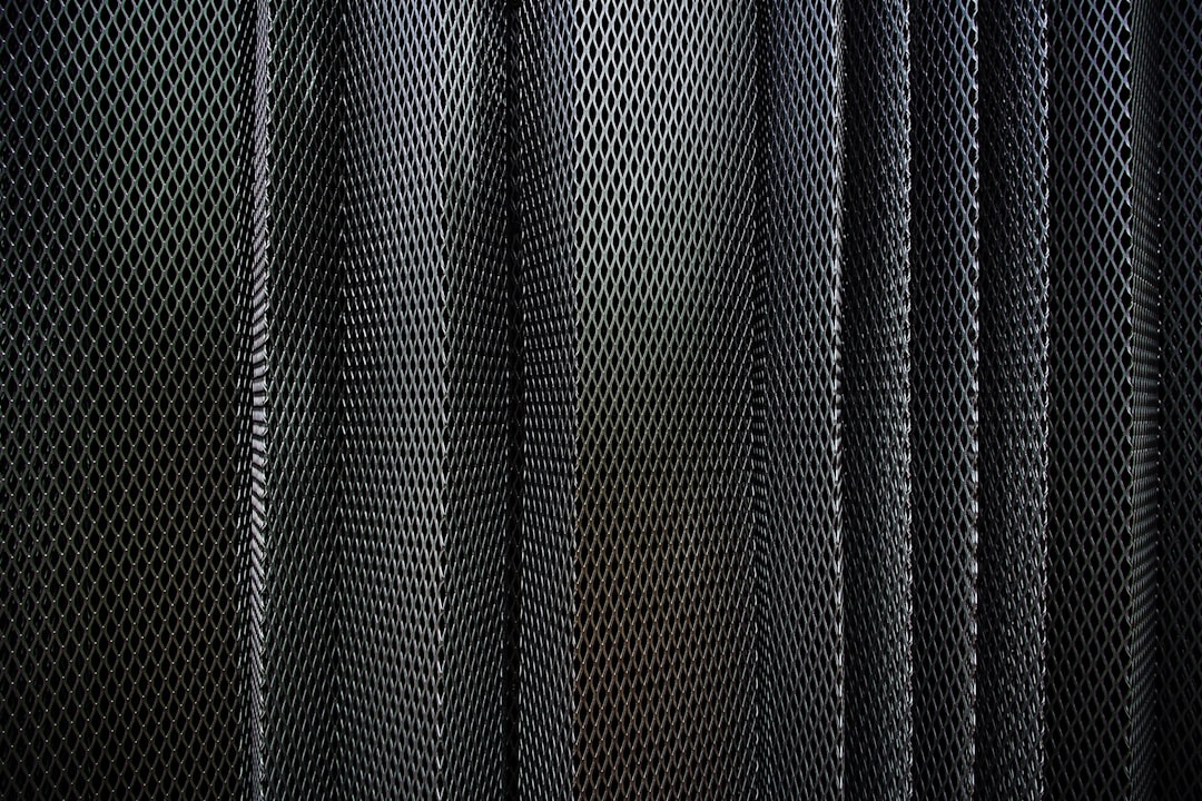 A metal criss-cross grid in undulating layers