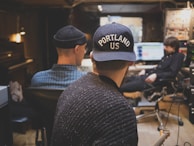 Behind-the-scenes shot of writers collaborating in a cozy Spokane studio filled with storyboards.