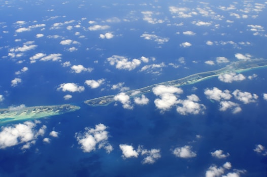 aerial photography of green island and clouds